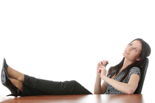 Young businesswoman relaxing at the desk, legs up, over white background