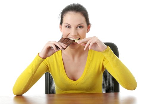 Portrait of young happy smiling woman eating dark and white chocolate