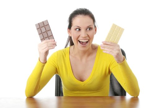 Portrait of young happy smiling woman eating dark and white chocolate