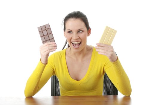 Portrait of young happy smiling woman eating dark and white chocolate