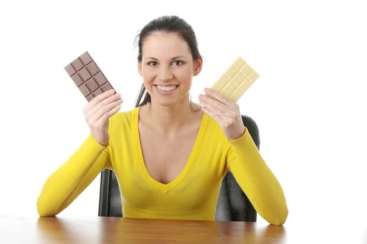 Portrait of young happy smiling woman eating dark and white chocolate