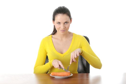 Young woman eating carrot from plate, isolated on white