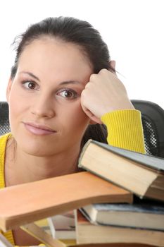Young woman sitting behind books