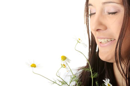 Beautiful young caucasian woman in bathrobe smeling daisy calm portrait. Isolated