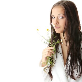 Beautiful young caucasian woman in bathrobe smeling daisy calm portrait. Isolated