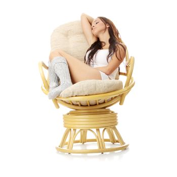 Beautiful young woman resting in armchair. Isolated on white background