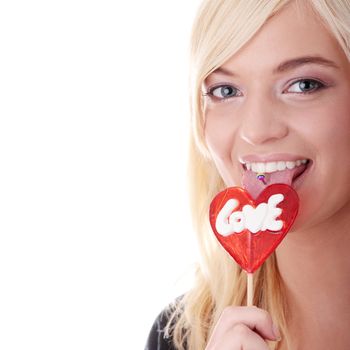 Teenage girl holding red heart shaped lollipop isolated