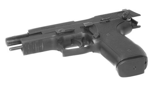 Semi-automatic handgun with slide back, isolated on a white background