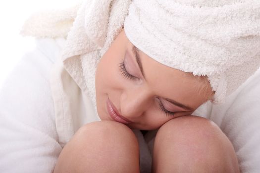 Portrait of young beautiful woman wearing bathrobe, isolated on white