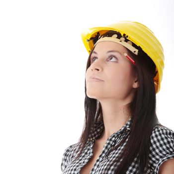 Engineer woman in yellow helmet looking up isolated on white background