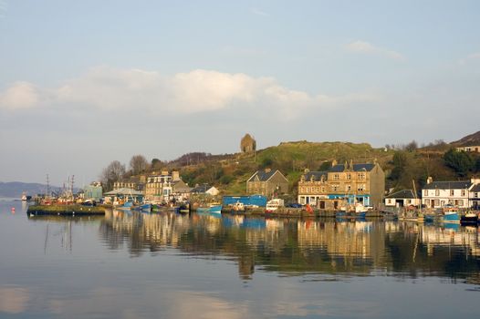 Town of Tarbert inScotland with Bruces tower on the hill