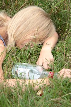 Teen alcohol addiction (drunk teen with vodka bottle)