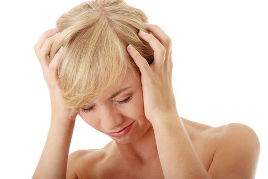 Woman with headache holding her hands to the head, isolated on white