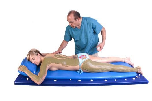 Woman getting Massage and seaweed treatment