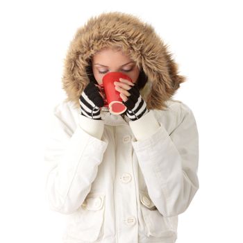 Teen winter girl with heart shaped red cup of hot drink (tea,coffee or milk)