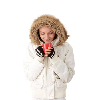 Teen winter girl with heart shaped red cup of hot drink (tea,coffee or milk)