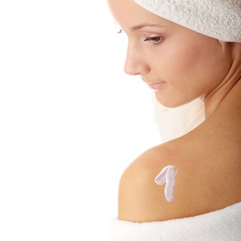 Skincare concept: back of beautiful nude woman with soft skin putting skincare product (cream) on her back - shaped one
