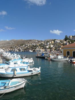 boats and yachts moored in a village in greece