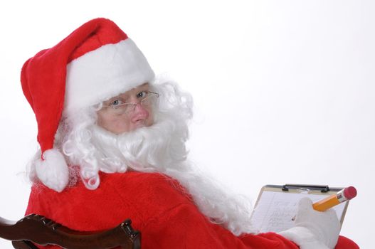 Pleasant middle-aged bearded man in a santa suit with pencil and notepad isolated on a white background
