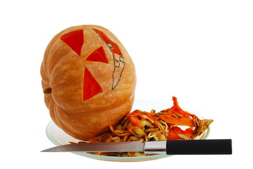 Halloween jack o lantern preparation - carving pumpkin with knife isolated on white background