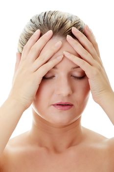 Woman with headache holding her hand to the head, isolated on white