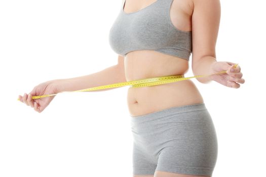 Woman measuring her waist isolated on white