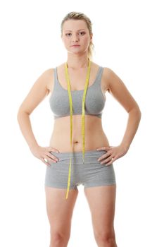 Woman measuring her waist isolated on white