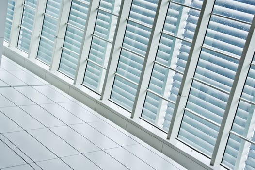 Contrast window panels with blinds beside tiled pathway