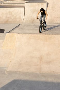 Asian Teenage boy on stunt bike ready to go.