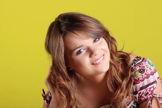 Teen woman portrait against green wall