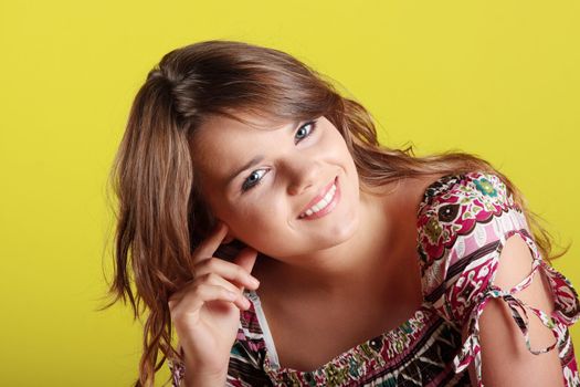Teen woman portrait against green wall