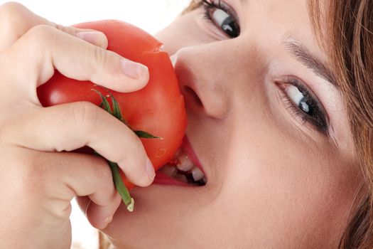 Young woman eating tomato isolated on white background