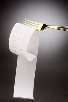 stock image of fork with the receipt on it