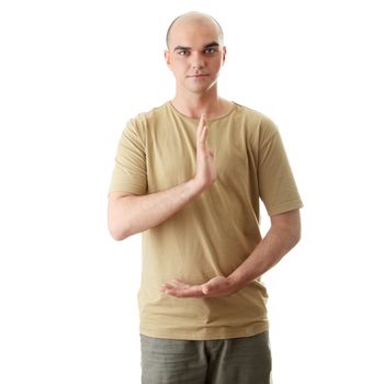 Man is making yoga in casual clothes isolated on white