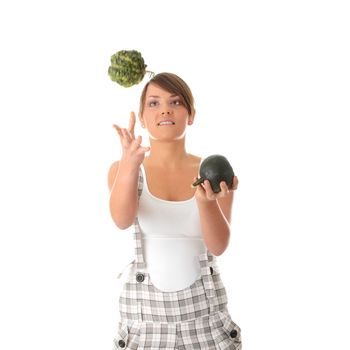 Teen woman juggle two smal pumpkins