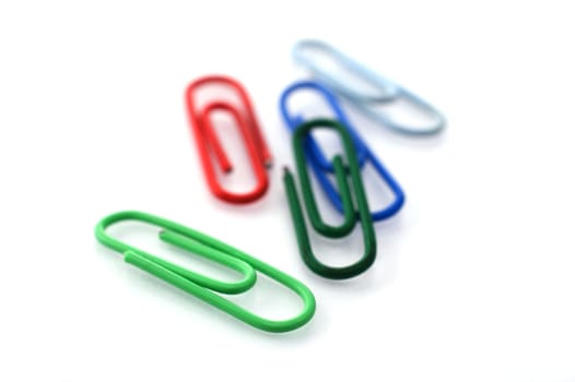 Colored paper clips isolated on white with shallow depth of field