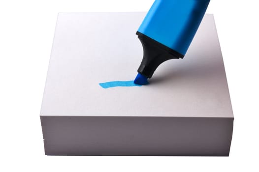 Blue highlighter on a stack of post-it notes isolated on white