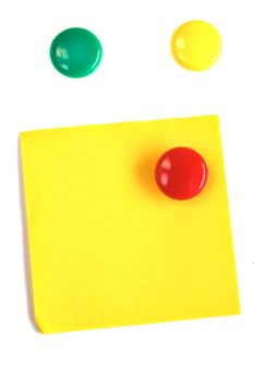 Round colored magnets with blank yellow post-it isolated on white