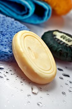 Wet soap with blu sponge and droplets with shallow depth of field
