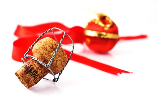 Champagne cork with red ribbon and ornament isolated on white with shallow depth of field