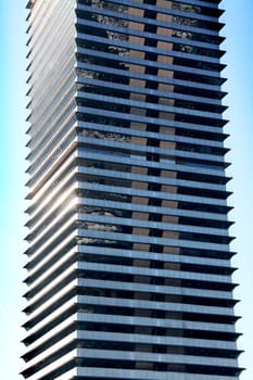 Business skycraper building, blue glass, clean sky background
