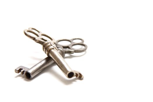 Isolated shot of two metal antique keys on white background