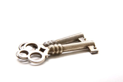 Isolated shot of two metal antique keys on white background