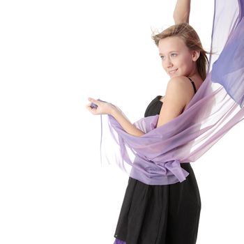Young beautiful blond teen woman in elegant, evening, black dress dancing with wind (hair blowing), isolated on white background.