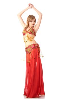 Teen girl in belly dancer costume dancing, isolated on white background