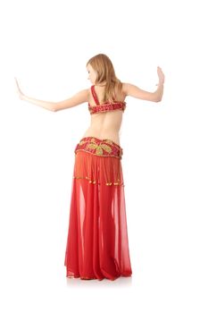 Teen girl in belly dancer costume dancing, isolated on white background