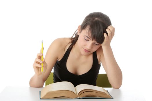Teen girl learning at the desk , isolated on white