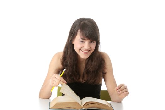 Teen girl learning at the desk , isolated on white