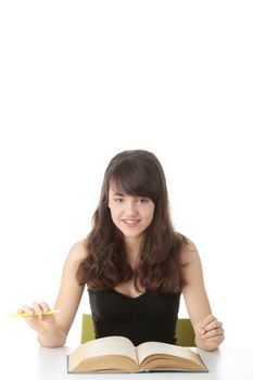 Teen girl learning at the desk , isolated on white