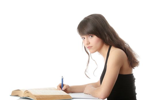 Teen girl learning at the desk, isolated on white